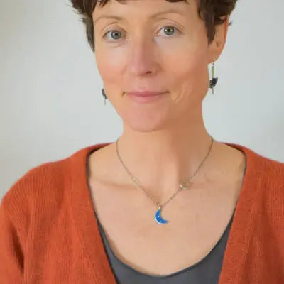 Woman wearing Lulu - Ford pickup pendant necklace with 18 inch oxidized sterling silver chain and blue crescent moon charm
