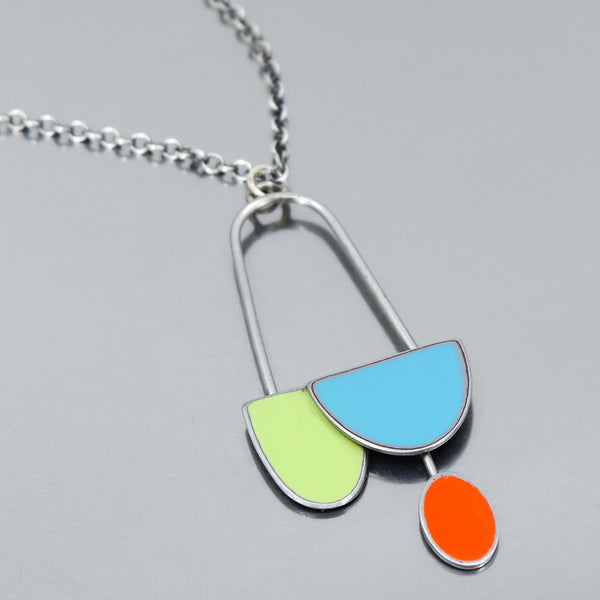 Sterling silver pendant necklace with colorful car paint pieces in green, turquoise, and orange on a chain.