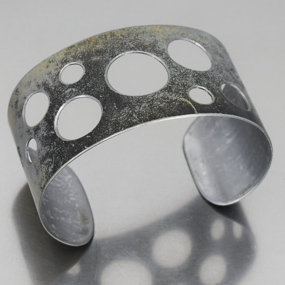 Adjustable Ira Ford Bronco bracelet made from 1986 Bronco with original paint, featuring circular cutout design.