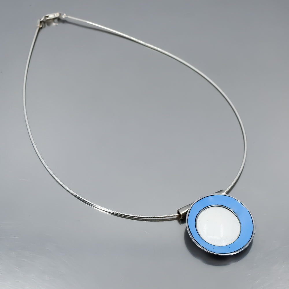 Sterling silver necklace with round pendant featuring light blue and white original car paint from 72 Chevy and 64 Ford models.
