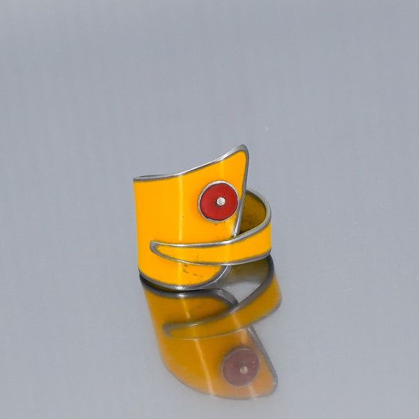 Yellow ring inspired by 1972 Ford pickup with original car paint and red detail, shown on reflective surface.