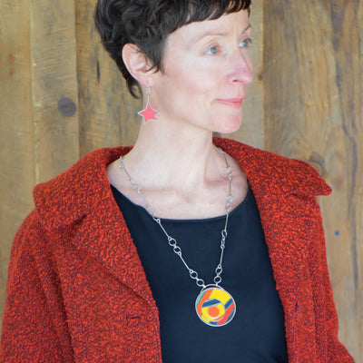Woman wearing Hattie - Ford earrings made from 86 Ford Bronco paint and sterling silver ear wires.