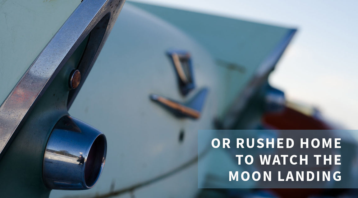 Close-up of the tail fin and taillight of a vintage car with original paint, with the text “OR RUSHED HOME TO WATCH THE MOON LANDING” overlaying the lower right corner.