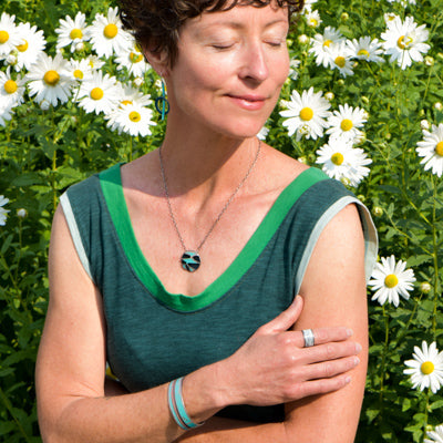 Sammy - Chevy pickup ring size 8 worn on woman’s hand with daisies in background outdoors.