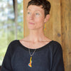Woman wearing Earnestine - Plymouth, Ford, Chevy earrings and necklace made with original car paint and silver wires.