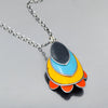 Rhoda - Ford: A pendant necklace with layered yellow, blue, and orange enamel shapes on a sterling silver chain, featuring an oval silver top piece and orange petal-like accents at the bottom, displayed on gray. Made from vintage car parts by Joyride Jewelry