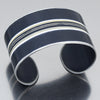 The Leroy - Mercedes Sprinter is a wide, cuff bracelet , black with parallel white and light stripes etched across the center. Adjustable fit. Made using vintage car parts with the original car paint intact. Handmade jewelry by Joyride Jewelry.
