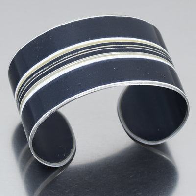 The Leroy - Mercedes Sprinter is a wide, cuff bracelet , black with parallel white and light stripes etched across the center. Adjustable fit. Made using vintage car parts with the original car paint intact. Handmade jewelry by Joyride Jewelry.