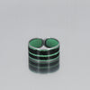 The Sonnie - Chevy Blazer is a adjustable ring featuring two green horizontal stripes and a black center band, shown on a reflective gray surface. Available in size 10. Handmade by Joyride Jewelry out of salvaged car parts.