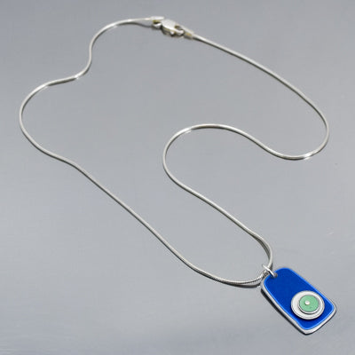 Marion - Ford & Dodge silver chain necklace with blue 75 Ford pickup pendant on gray background.