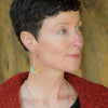 Woman wearing Harvey - Ford & Chevy earrings made from original car paint and sterling silver ear wires