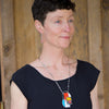 Maude - Ford & GMC necklace worn by model featuring original car paint on sterling silver chain pendant.