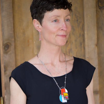 Maude - Ford & GMC necklace worn by model featuring original car paint on sterling silver chain pendant.