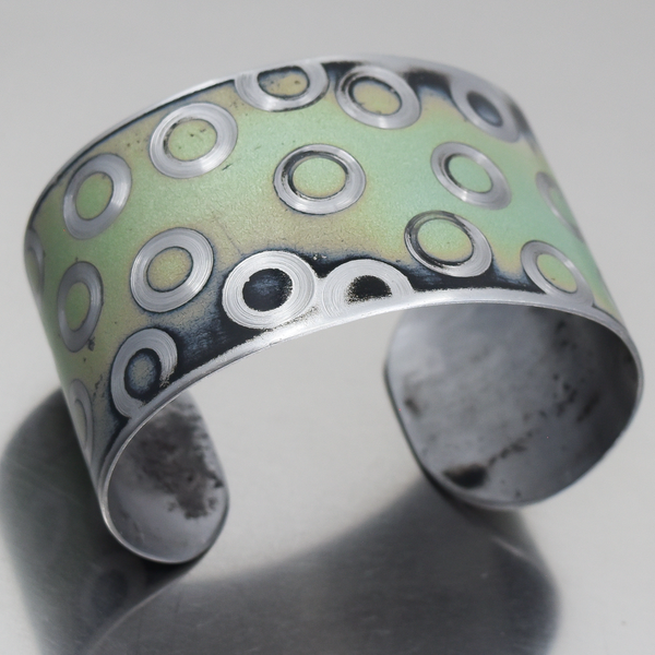 Clarence - Chevy Nova bracelet featuring original car paint with circular metal design, adjustable fit for wrists 5 3/4" to 6 1/2".