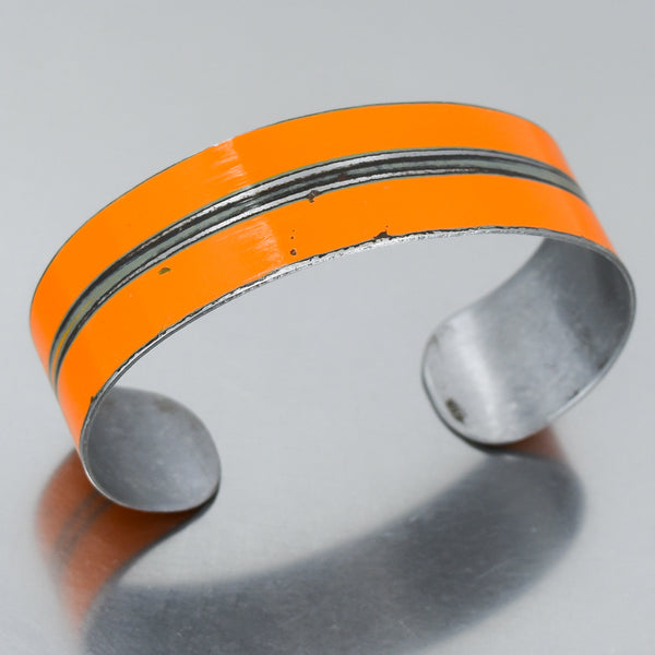 orange cuff bracelet made from a 1960 AMC Rambler with the original car paint intact. Joyride Jewelry. Jewelry made from vintage cars.