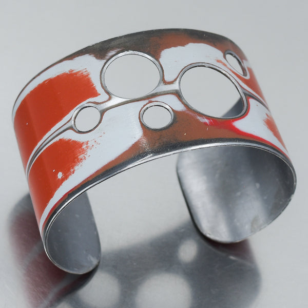 red and white cuff bracelet with cut out holes. Made from a 1955 Jeep Willys station wagon with the original car paint intact. Joyride Jewelry. Jewelry made from vintage cars.