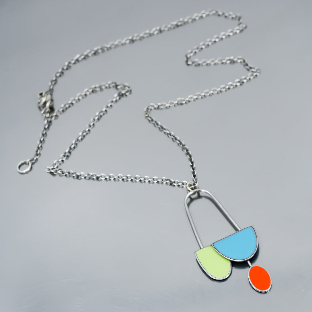 handmade green, turquoise and orange pendant or necklace using vintage car parts with the original car paint intact. Joyride Jewelry. Jewelry made from vintage car parts. 
Fun, unique, original, colorful
mid century modern, retro vibe
sustainable, recycled 