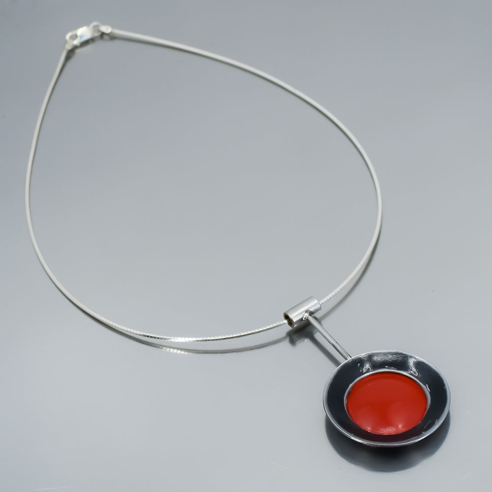 black and red necklace, pendant hung on a sterling silver cable.   handmade using vintage car parts with the original car paint intact. Joyride Jewelry. Jewelry made from vintage car parts. Made from a black 86 Ford Bronco and a red 69 Mercury. Fun, unique, original,