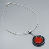 black and red necklace, pendant hung on a sterling silver cable.   handmade using vintage car parts with the original car paint intact. Joyride Jewelry. Jewelry made from vintage car parts. Made from a black 86 Ford Bronco and a red 69 Mercury. Fun, unique, original,