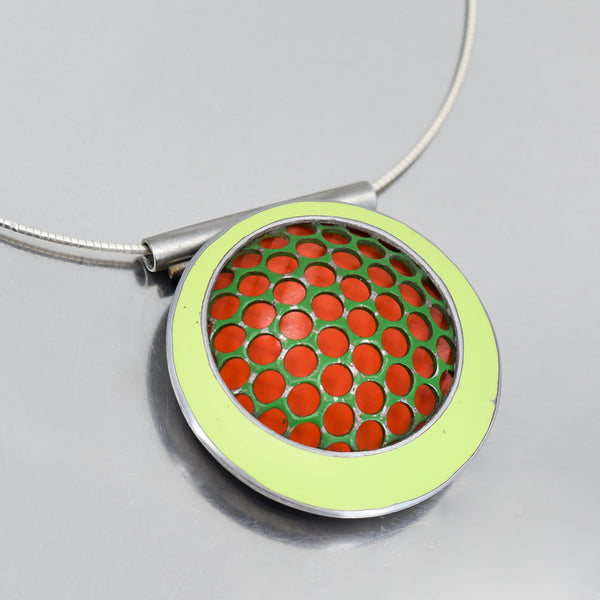 orange and green circular pendant necklace handmade using vintage car parts with the original car paint intact. Joyride Jewelry. Jewelry made from vintage car parts. 74 Ford pickup , 73 Plymouth Satellite. Sterling silver cable.
Fun, unique, original, colorful, bold,
sustainable, recycled , retro vibe. circles
