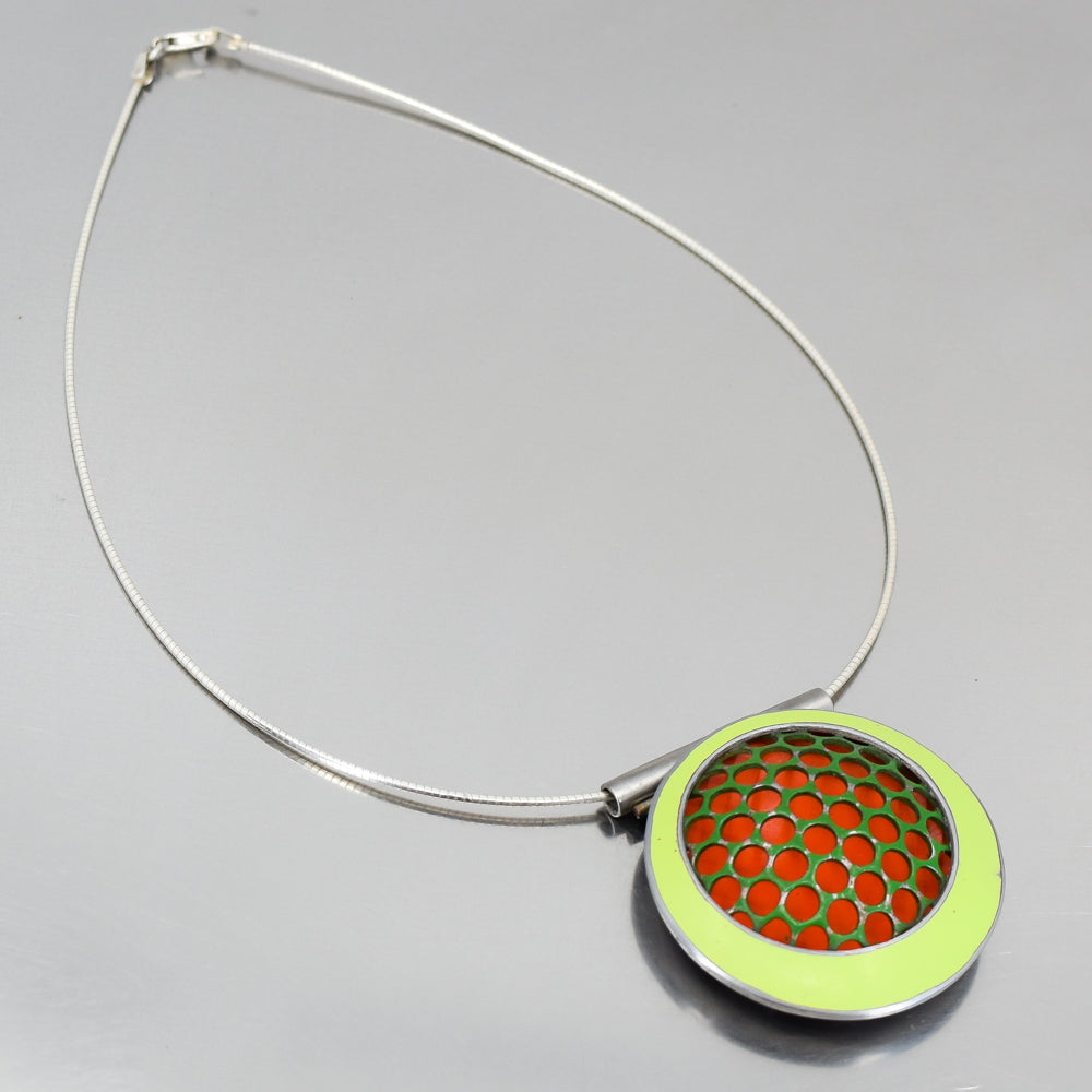 orange and green circular pendant necklace handmade using vintage car parts with the original car paint intact. Joyride Jewelry. Jewelry made from vintage car parts.74 Ford pickup , 73 Plymouth Satellite. Sterling silver cable.
Fun, unique, original, colorful, bold,
sustainable, recycled , retro vibe. circles