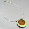 orange and green circular pendant necklace handmade using vintage car parts with the original car paint intact. Joyride Jewelry. Jewelry made from vintage car parts.74 Ford pickup , 73 Plymouth Satellite. Sterling silver cable.
Fun, unique, original, colorful, bold,
sustainable, recycled , retro vibe. circles