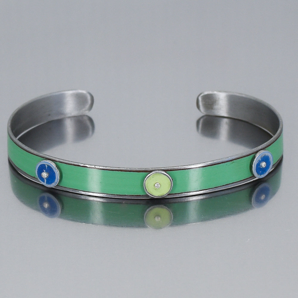 turquoise bracelet with blue and green circles or dots. handmade using vintage car parts with the original car paint intact. Joyride Jewelry. Jewelry made from vintage car parts. 
Fun, unique, original, colorful
sustainable, recycled 
