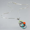 Sterling silver necklace with pendant featuring original car paint from Plymouth, Oldsmobile, Ford, and Chevy models.