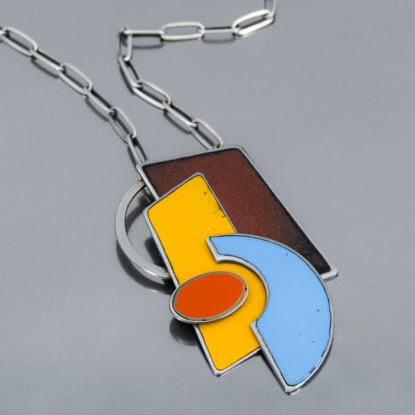 Abstract pendant necklace with copper, yellow, blue, and orange enamel inspired by vintage International Scout and Ford pickup paint.