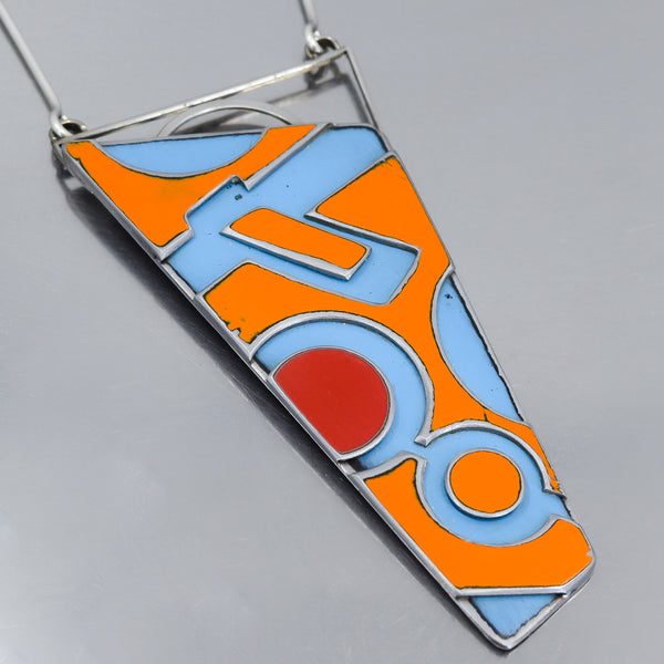 Triangular pendant necklace with orange, blue, and red car paint from vintage International Scout and Ford Falcon on silver chain