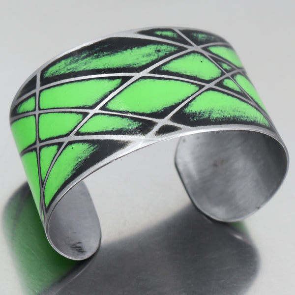 Silver cuff bracelet with bright green and black enamel inspired by a 1978 Ford Bronco painted metal design