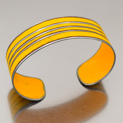 The Norbert - 72 Ford pickup bracelet features a yellow cuff with three parallel etched lines, made from vintage car parts with the original car paint intact. Handmade jewelry by Joyride Jewelry.