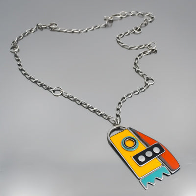 Arline - Ford & GMC pendant necklace with original car paint on sterling silver chain displayed on gray surface.