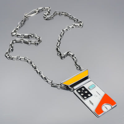 Anita - Ford & Dodge necklace with salvaged car paint pendant and oxidized sterling silver chain on gray background.