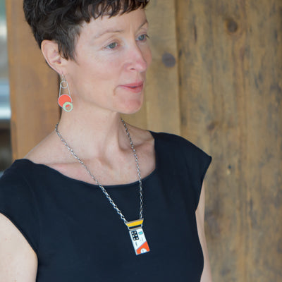 Anita - Ford & Dodge pendant necklace in original car paint on oxidized sterling silver chain worn by model.