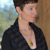 Arline - Ford & GMC pendant necklace worn by woman, featuring colorful oxidized sterling silver chain and car paint design.