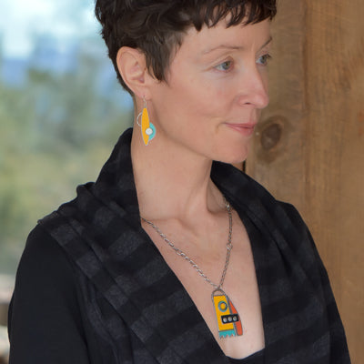 Arline - Ford & GMC pendant necklace worn by woman, featuring colorful oxidized sterling silver chain and car paint design.