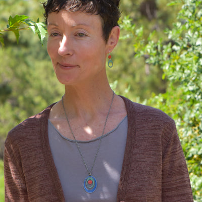 Earnestine - Ford & Dodge pendant necklace with oxidized sterling silver chain worn by woman outdoors