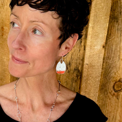 Addie - Ford Bronco sterling silver earrings featuring original 86 Ford Bronco paint worn by woman against wooden background.