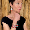 Woman wearing Elwood - red Jeep Willys bracelet with original Jeep Willys paint. Handmade original jewelry with the original car paint intact. Joyride Jewelry. Jewelry made from vintage cars.