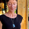 Woman wearing Lana pendant necklace made from original car paint on oxidized sterling silver chain