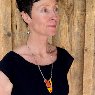 Lottie - Ford necklace featuring 74 Ford F150 orange and 72 Ford pickup yellow paint on oxidized silver chain worn on model.