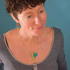 Hazel - Ford & AMC necklace featuring turquoise 64 Ford Fairlane and light turquoise 62 AMC Rambler pendant on silver cable.